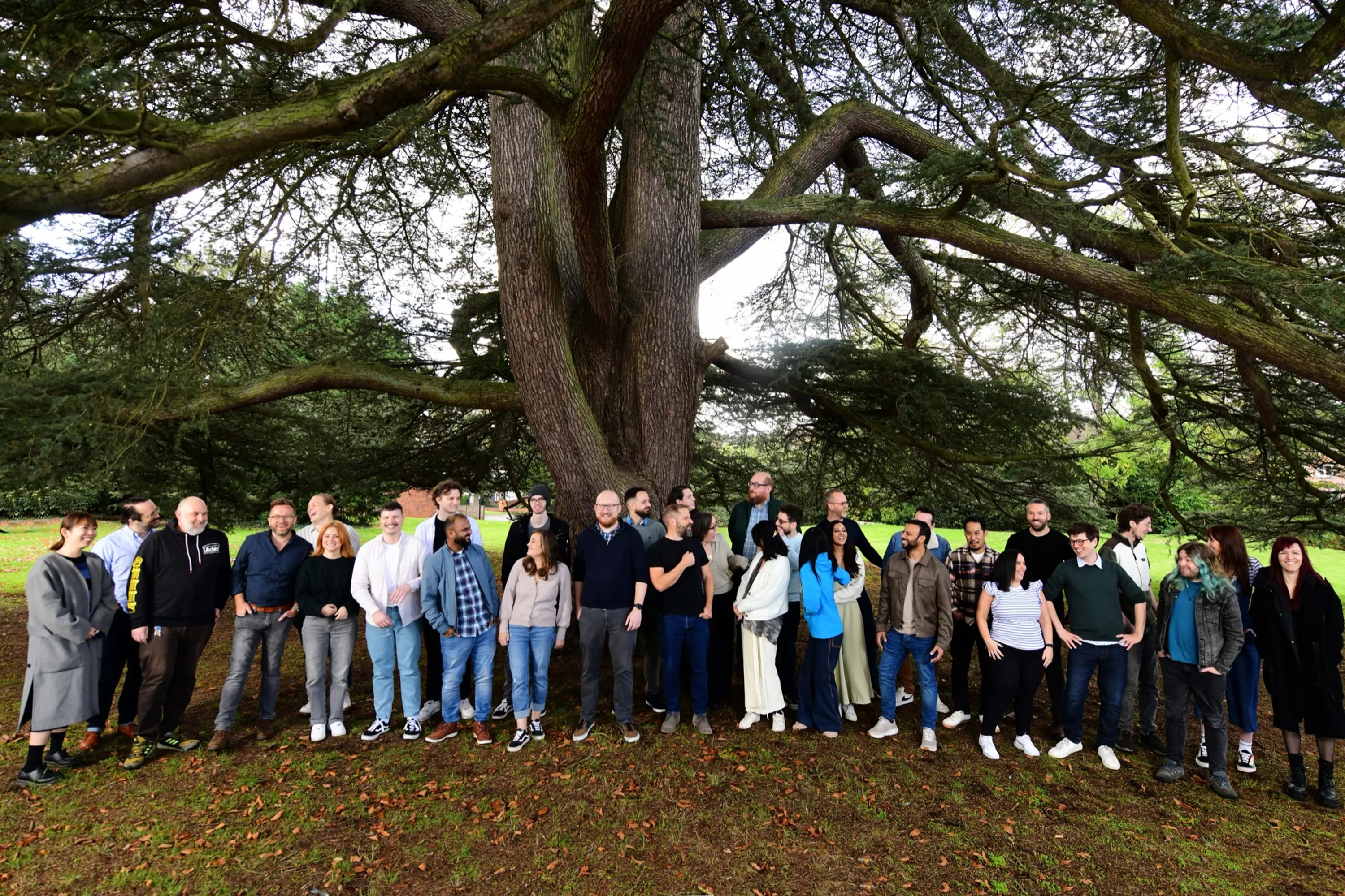 The Made team gathered outdoors under a large tree